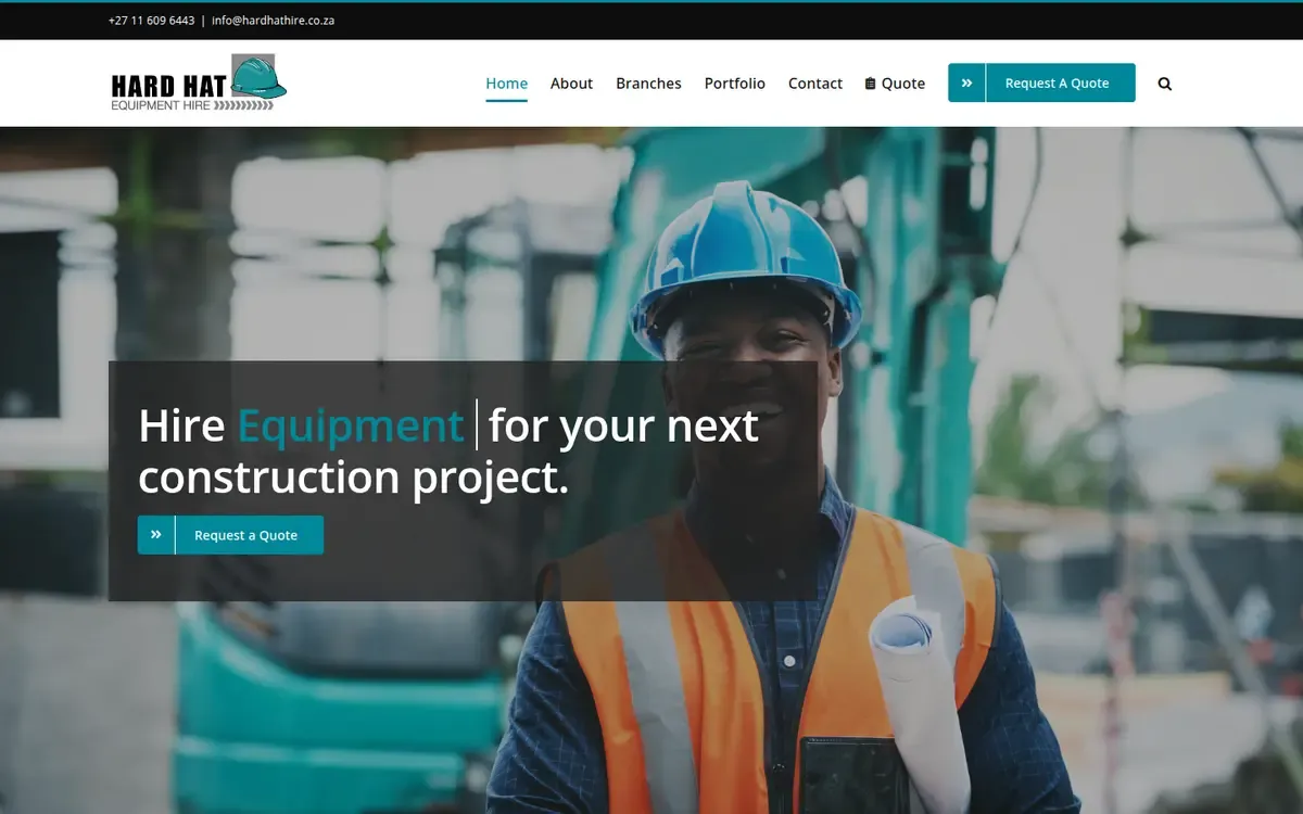 The Hard Hat Equipment Hire home page: a smiling worker in a blue hard hat and orange safety vest, holding rolled plans, behind the line “Hire Equipment for your next construction project.” and a Request a Quote button.